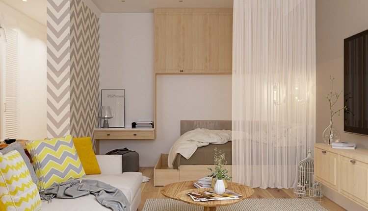 يتضمن السرير في غرفة المعيشة فكرة أريكة بنمط متعرج أصفر ورمادي
