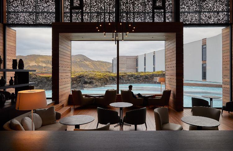 فندق مع حمام حراري في أيسلندا ، براكين منقرضة ، بحيرة زرقاء ، تصميم رفاهية ، منطقة استقبال طبيعية فاخرة ، ألواح خشبية