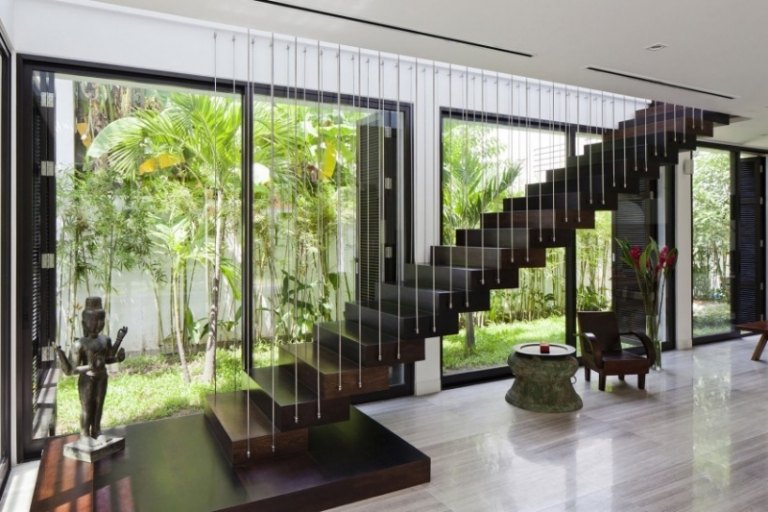 غرفة المعيشة-verikaler-garden-harp-stairs-dark-wood-wall-glazing